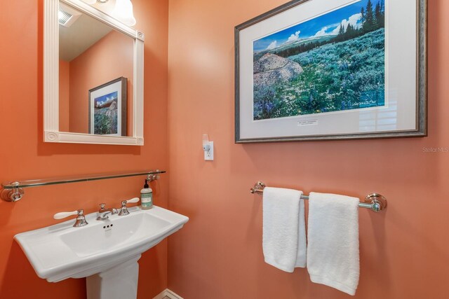 bathroom featuring visible vents and a sink