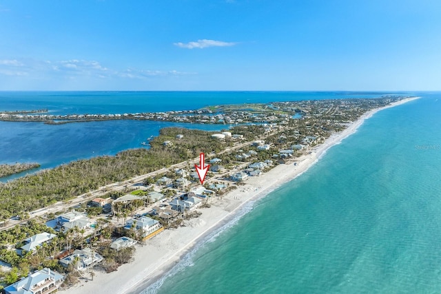 drone / aerial view with a water view and a view of the beach