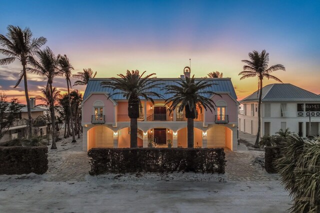 view of front of house featuring a balcony and stucco siding