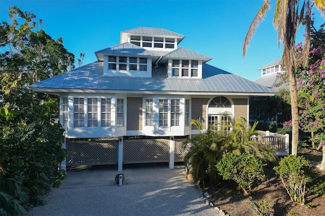 view of front of house featuring metal roof, a carport, and concrete driveway