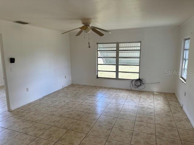 1417 Terry Ave, Punta Gorda, FL 33980 - spare room featuring visible vents, ornamental molding, a ceiling fan, and tile patterned floors