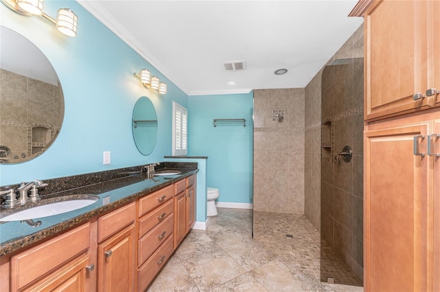 bathroom with visible vents, a walk in shower, baseboards, ornamental molding, and a sink