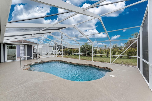 outdoor pool with glass enclosure, a patio, and a yard