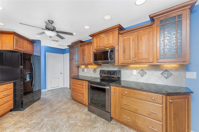 kitchen featuring stainless steel appliances, glass insert cabinets, and brown cabinetry