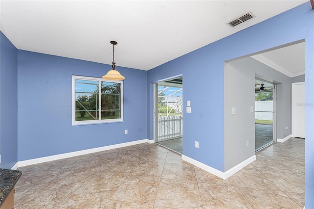 unfurnished room with baseboards, visible vents, and ornamental molding