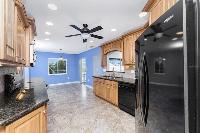 kitchen featuring ceiling fan, black appliances, baseboards, and a sink