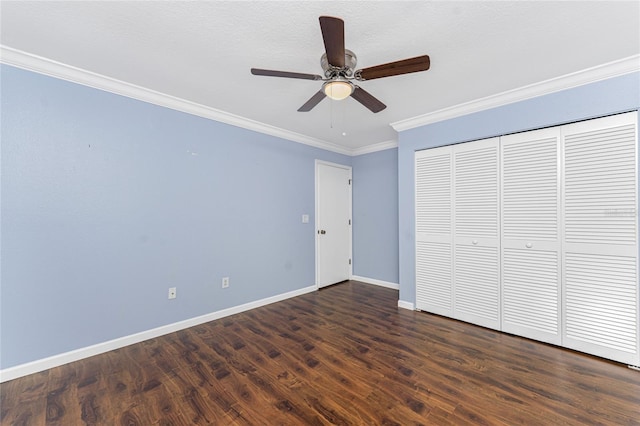 unfurnished bedroom featuring baseboards, a ceiling fan, ornamental molding, and dark wood-style flooring