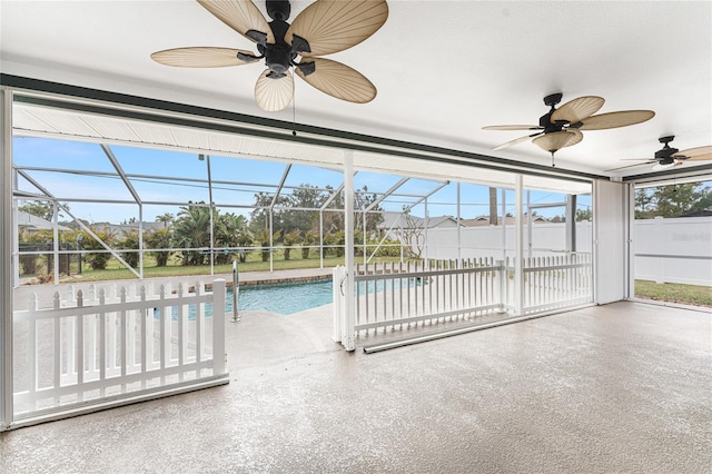 view of pool with a fenced in pool, ceiling fan, fence, a lanai, and a patio