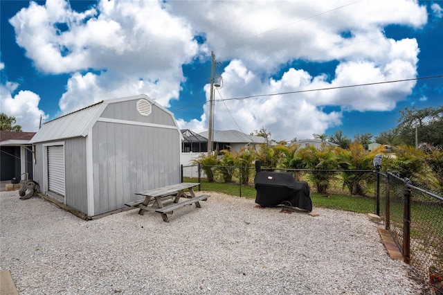 view of shed featuring fence