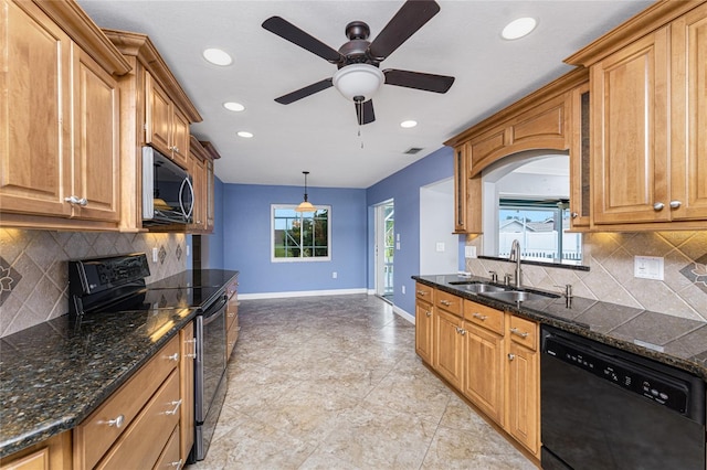 kitchen with brown cabinetry, visible vents, baseboards, a sink, and black appliances