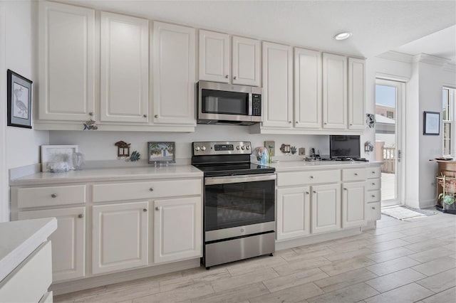 kitchen featuring stainless steel appliances and white cabinets