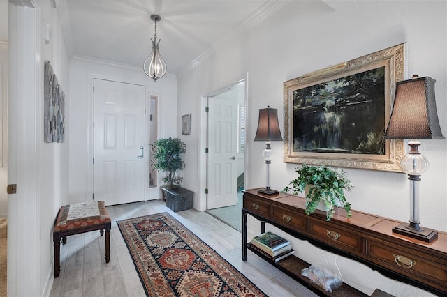 entrance foyer featuring light wood-type flooring and crown molding