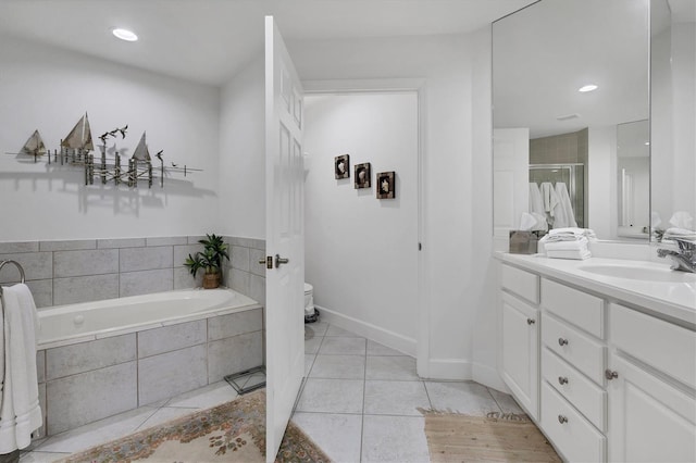 bathroom featuring toilet, a garden tub, tile patterned flooring, and vanity