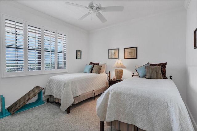 carpeted bedroom with a ceiling fan and crown molding