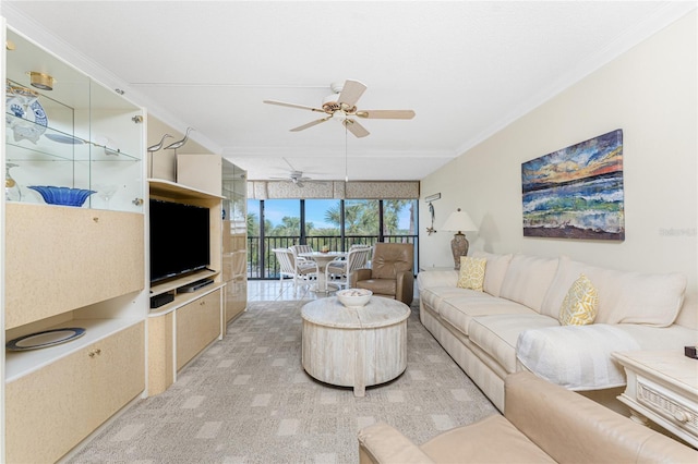 living room with a ceiling fan and crown molding