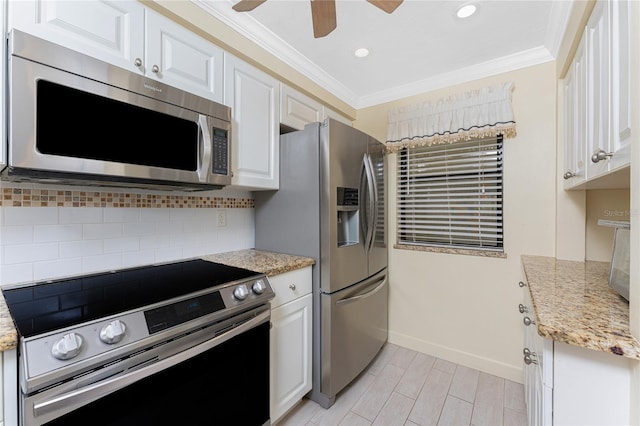 kitchen featuring appliances with stainless steel finishes, white cabinets, and crown molding