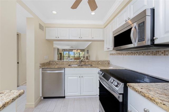 kitchen featuring stainless steel appliances, a sink, visible vents, tasteful backsplash, and crown molding