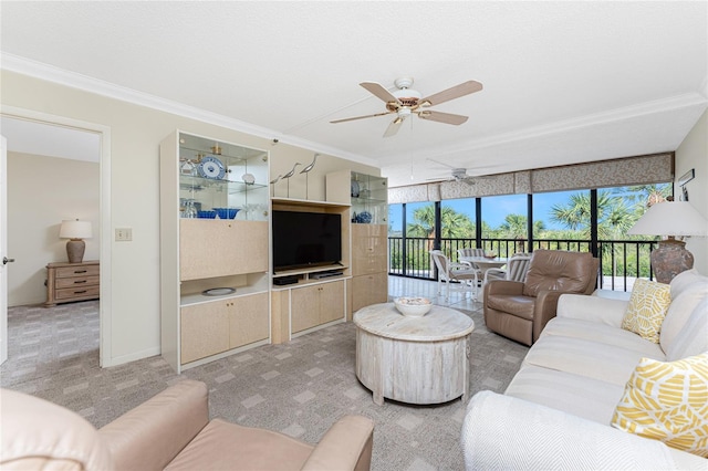 living room featuring plenty of natural light, ornamental molding, and light colored carpet