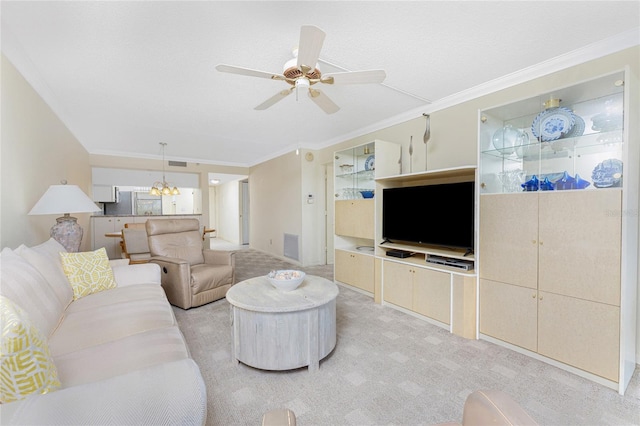 living area with crown molding, ceiling fan with notable chandelier, visible vents, and light colored carpet