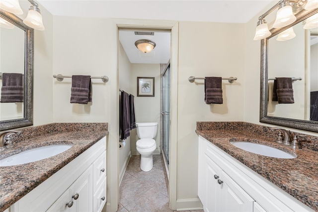 full bathroom with two vanities, a sink, and toilet