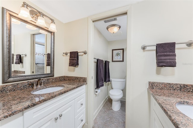 bathroom featuring tile patterned flooring, two vanities, a sink, and toilet