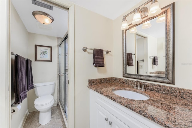 bathroom featuring a shower stall, vanity, toilet, and tile patterned floors