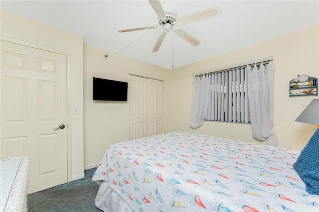 bedroom featuring a ceiling fan, dark colored carpet, a closet, and baseboards