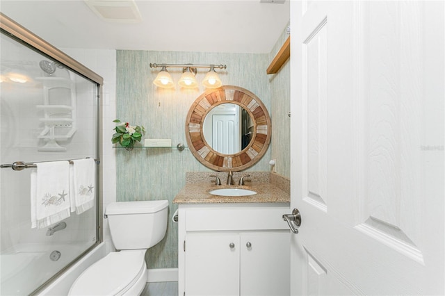 bathroom featuring visible vents, toilet, combined bath / shower with glass door, vanity, and wallpapered walls