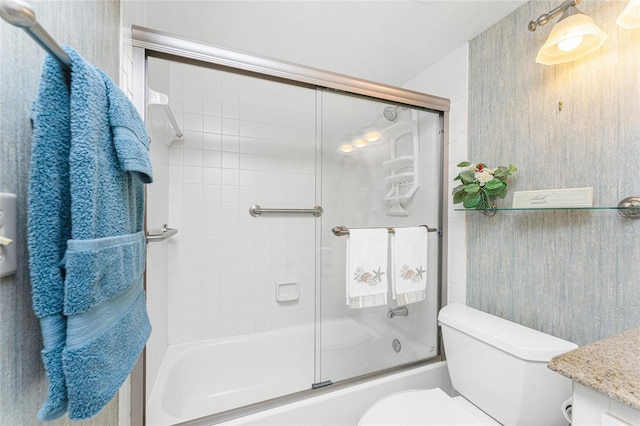 full bathroom featuring vanity, toilet, and bath / shower combo with glass door