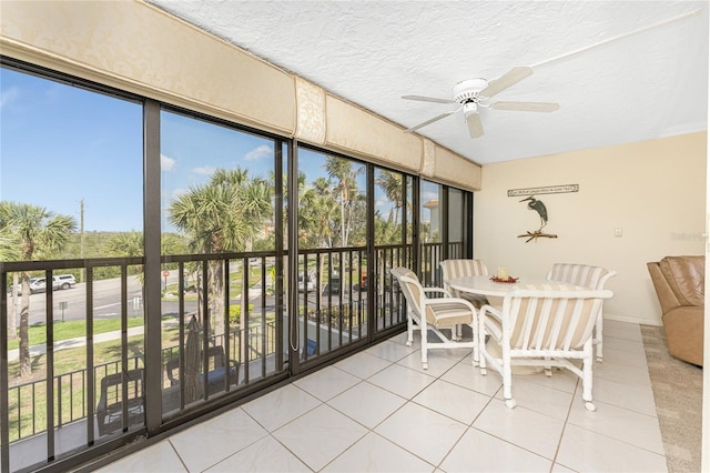 unfurnished sunroom with a wealth of natural light and ceiling fan