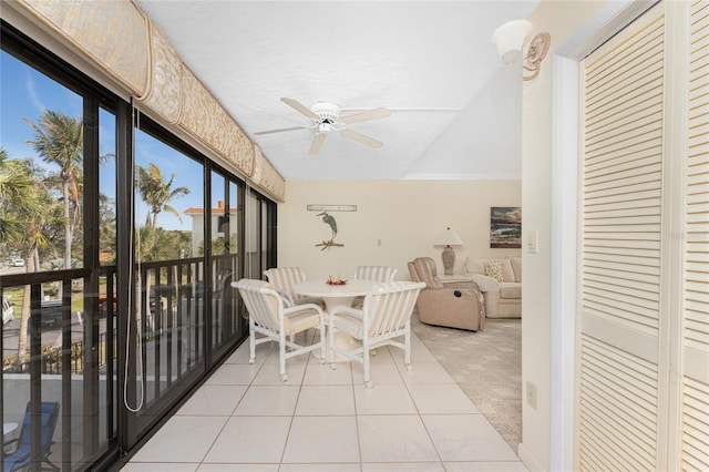 sunroom / solarium featuring ceiling fan