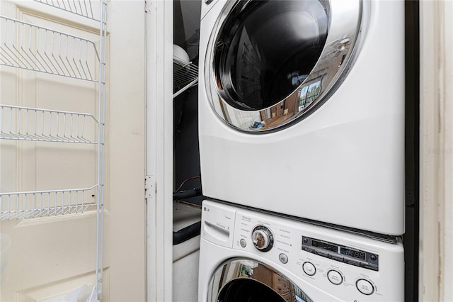 laundry room with laundry area and stacked washer / dryer