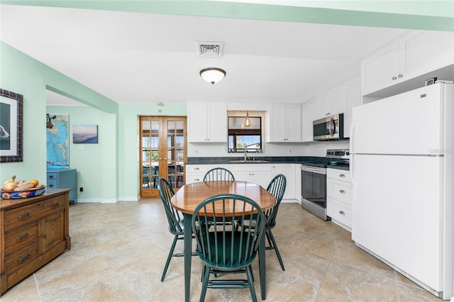 dining room with french doors, visible vents, and baseboards