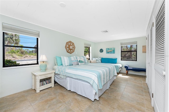 bedroom featuring multiple windows and visible vents