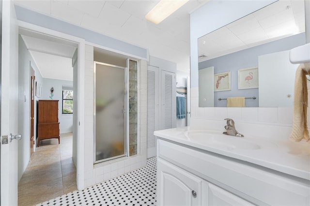 bathroom with a stall shower and vanity