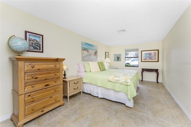 bedroom with baseboards and visible vents