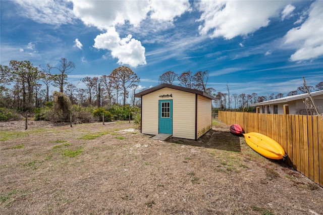 view of shed with fence