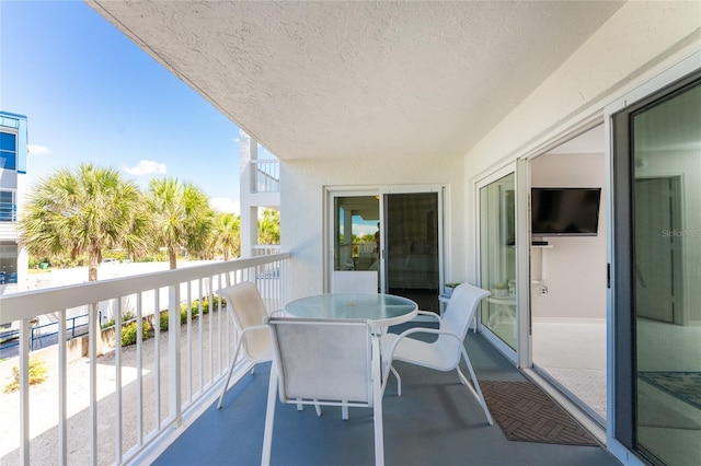 balcony featuring outdoor dining space and a sunroom