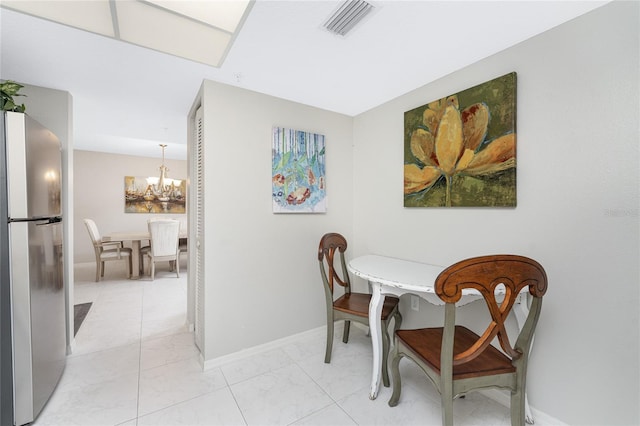 dining area with baseboards, marble finish floor, visible vents, and an inviting chandelier