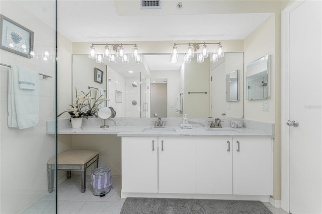 full bath with double vanity, an enclosed shower, a sink, and visible vents