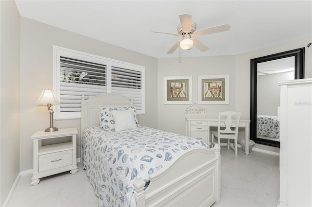 bedroom featuring ceiling fan, marble finish floor, and baseboards