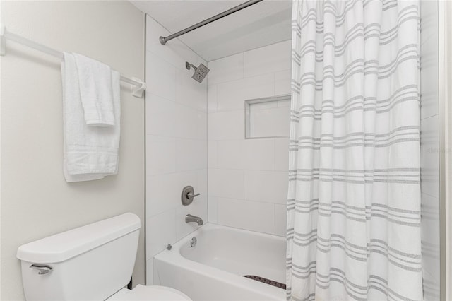 bathroom with shower / bath combination with curtain and toilet