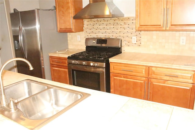 kitchen with stainless steel appliances, light countertops, extractor fan, and a sink