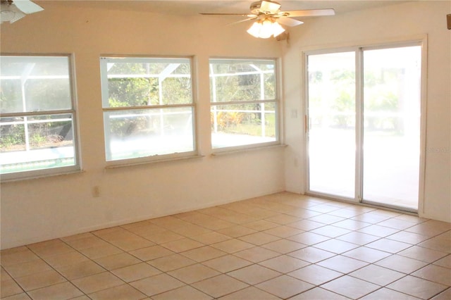 unfurnished sunroom with ceiling fan