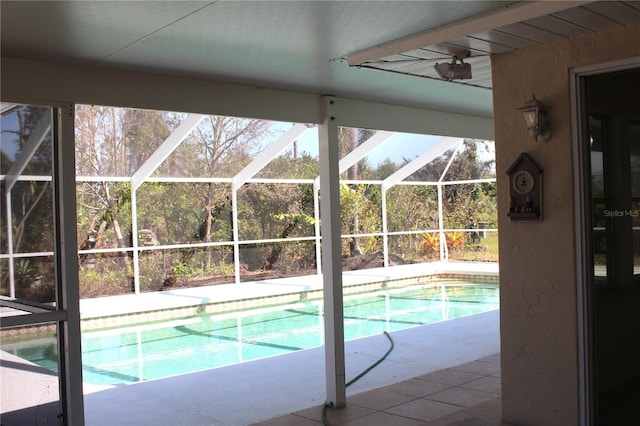 outdoor pool with a patio area and glass enclosure