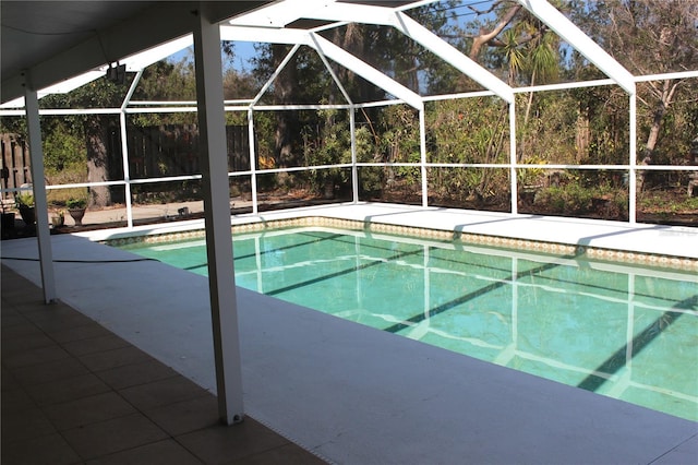 outdoor pool with a lanai and a patio area