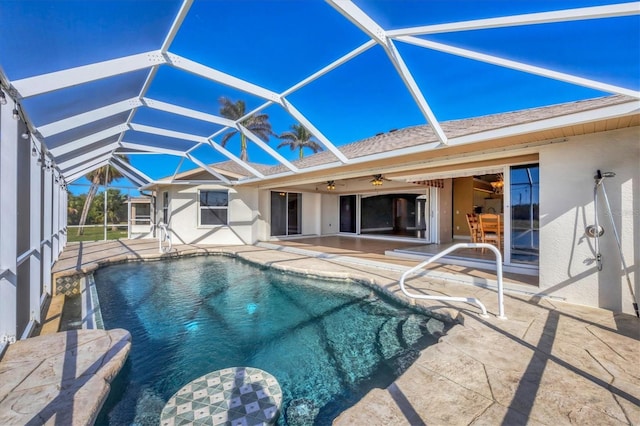 pool with a ceiling fan, glass enclosure, and a patio