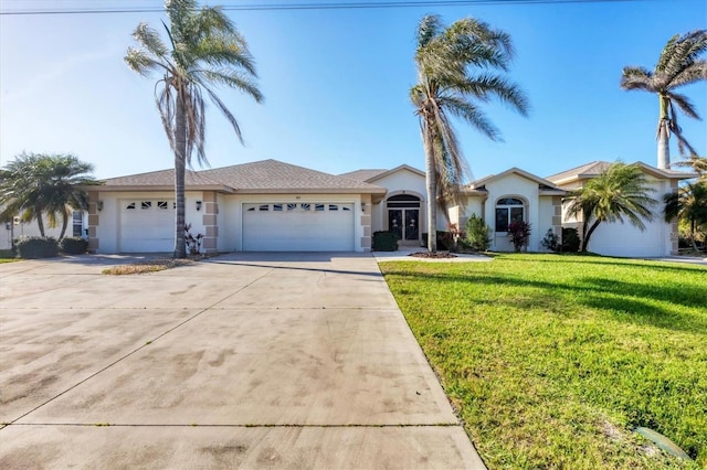 ranch-style home featuring concrete driveway, a front yard, an attached garage, and stucco siding