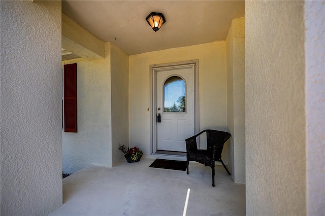 entrance to property with stucco siding