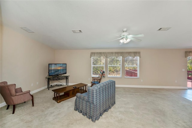 living room featuring light carpet, baseboards, visible vents, and ceiling fan